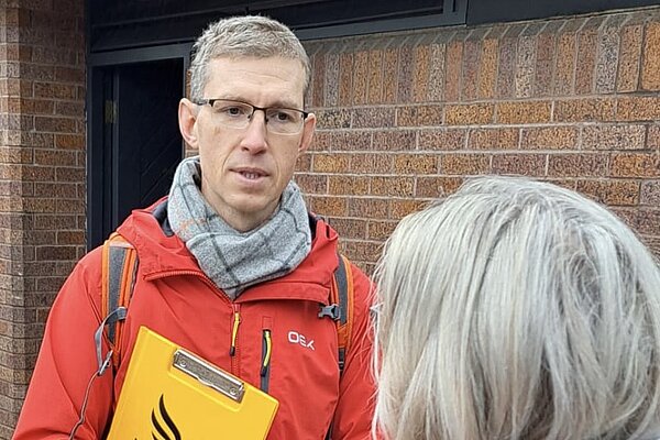 Volunteer speaking with a member of the public.